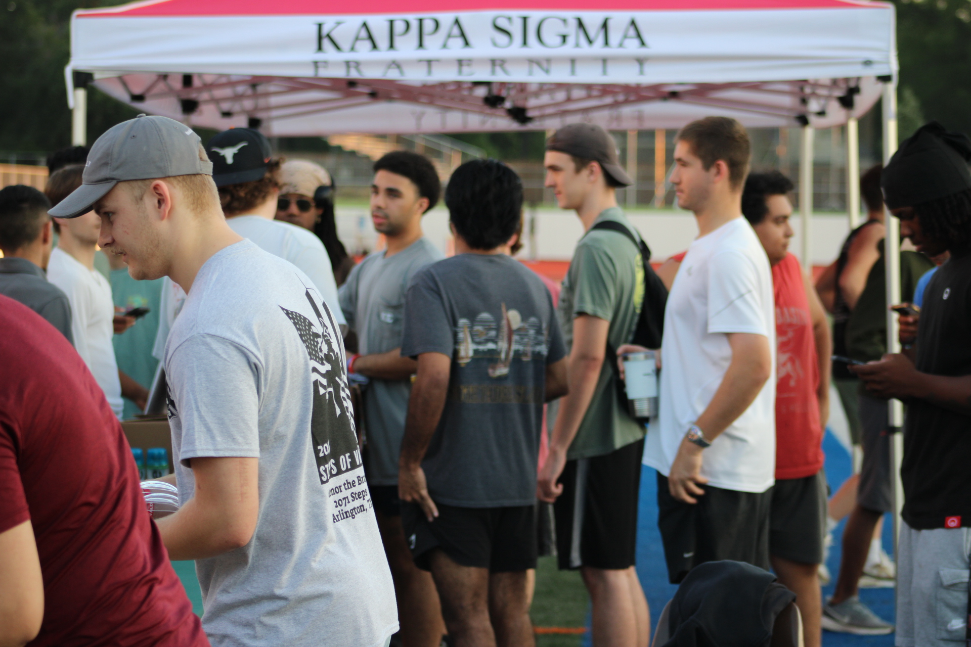 Attendees gathering beneath the event tent